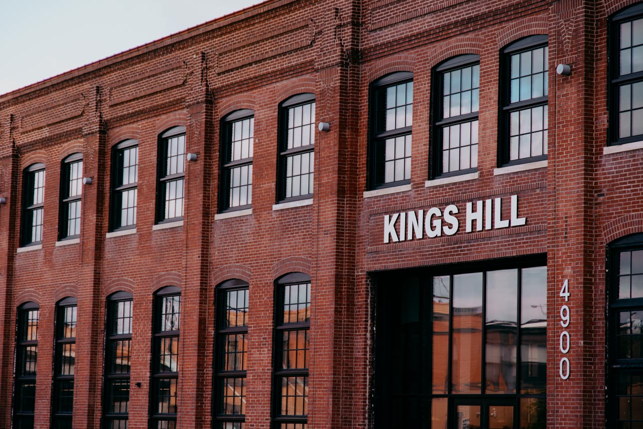 Historic brick building with large black historic replica windows