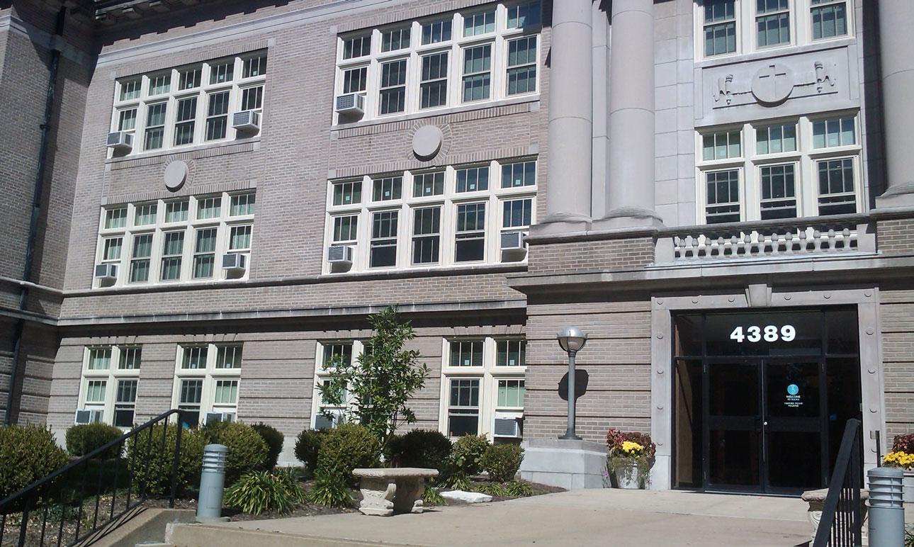 Rosati Kain uses WINCO's 4410S single hung windows with custom panning, snap trim, and a crisp painted Kynar finish to match the original wood frame windows.