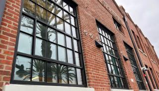 Close up of large brick building and window with grids