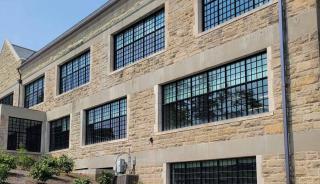 Brick building with large windows and playground