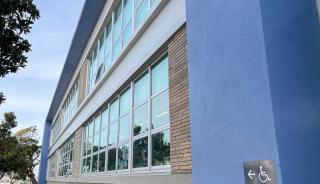 Side of school with windows and ADA sign