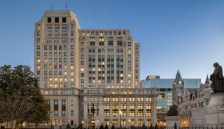 Dusk view of the historic General Assembly Building, beautifully lit, with a statue in front and Winco's 3250 series windows.