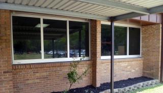 A brick building featuring multiple windows, showcasing a classic architectural design
