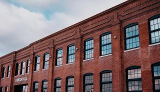Historic brick building with large black steel replica windows