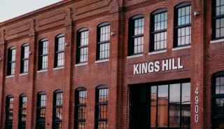 Historic brick building with large black historic replica windows